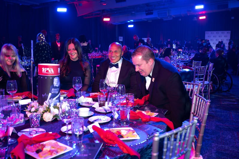PVA Member Marco (center) enjoys dinner with guests at PVA's 2022 Gala in Indianapolis.