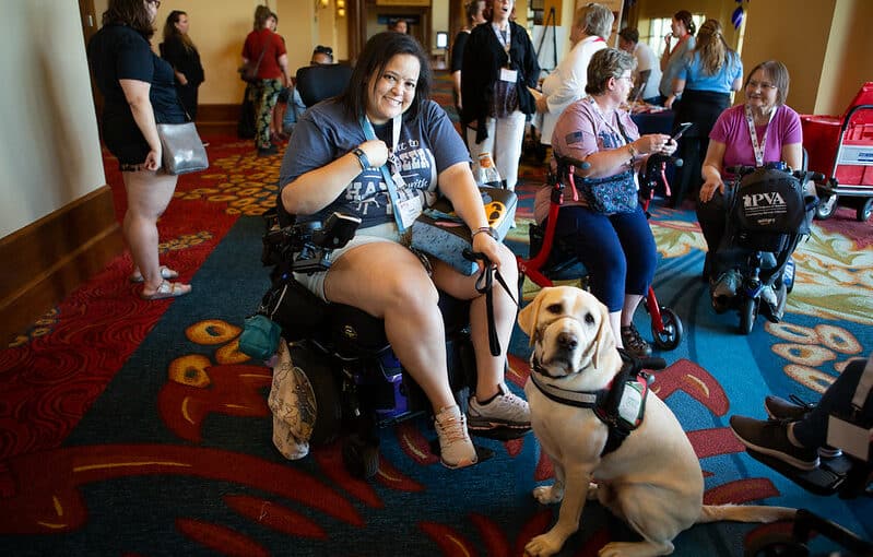 Air Force Veteran Tonya poses with her service dog Herman at the 2022 PVA Women Veterans Empowerment Retreat