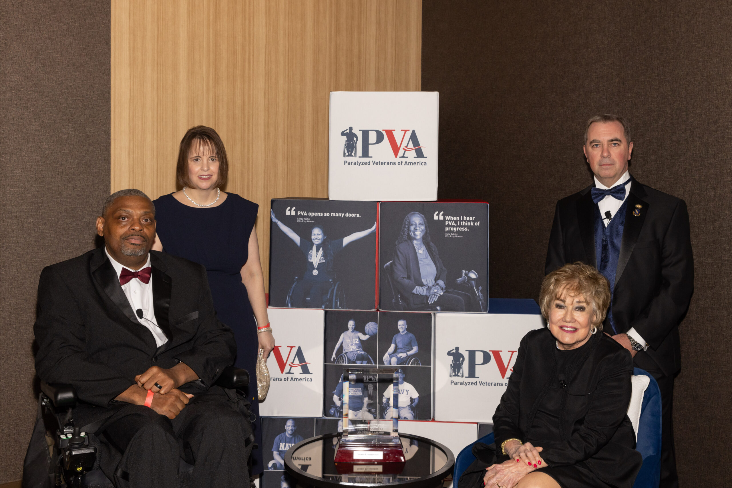 Four people pose for a photo at the PVA Igniting Change Gala.