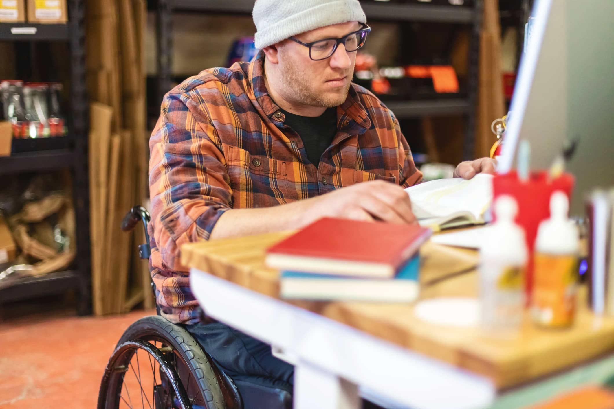 Caucasian man in a wheelchair reading a book