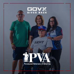 Four people, including one in a wheelchair wearing an 